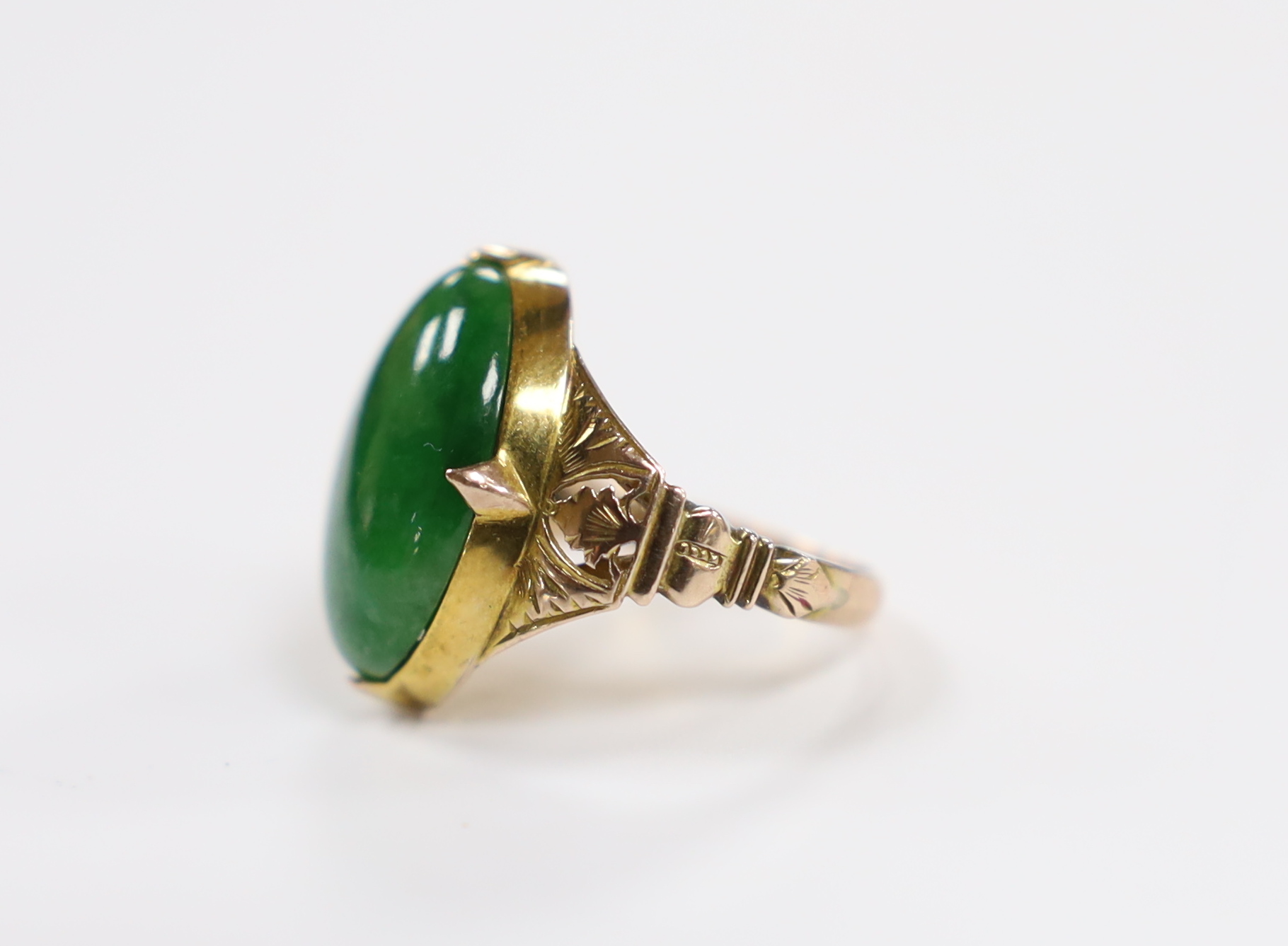 A Chinese 14k yellow metal and oval cabochon jade set ring, size I, gross weight 5.4 grams.